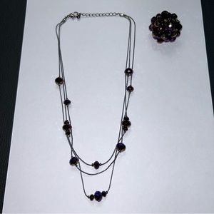 Purple and charcoal colored necklace and ring set.